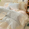 Pastel pink gingham ruffle bedding set with cream frilled edges, soft cotton duvet cover and pillowcases in romantic shabby chic bedroom decor