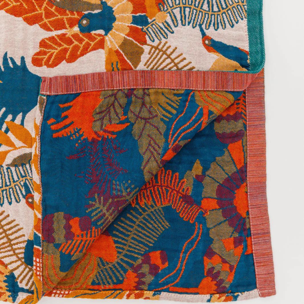 Reversible beach towel with tropical floral pattern in vibrant blue, orange, and green, quick-dry cotton for pool or seaside