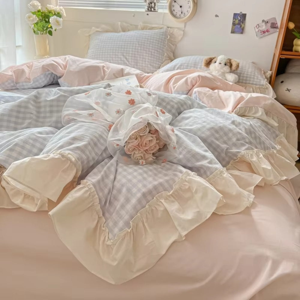 Pastel pink gingham ruffle bedding set with cream frilled edges, soft cotton duvet cover and pillowcases in romantic shabby chic bedroom decor