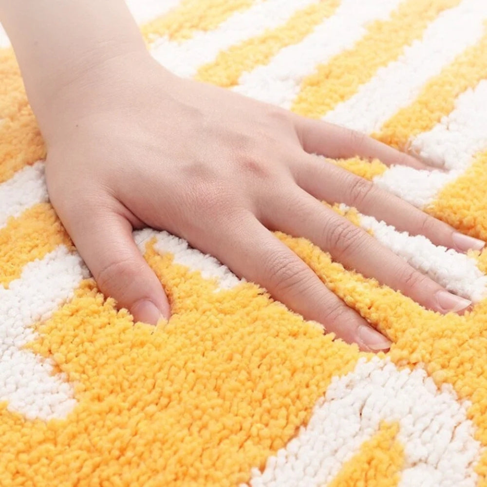 Yellow lemon-shaped bathroom rug with white text ‘Squeeze the Day’, soft absorbent bath mat