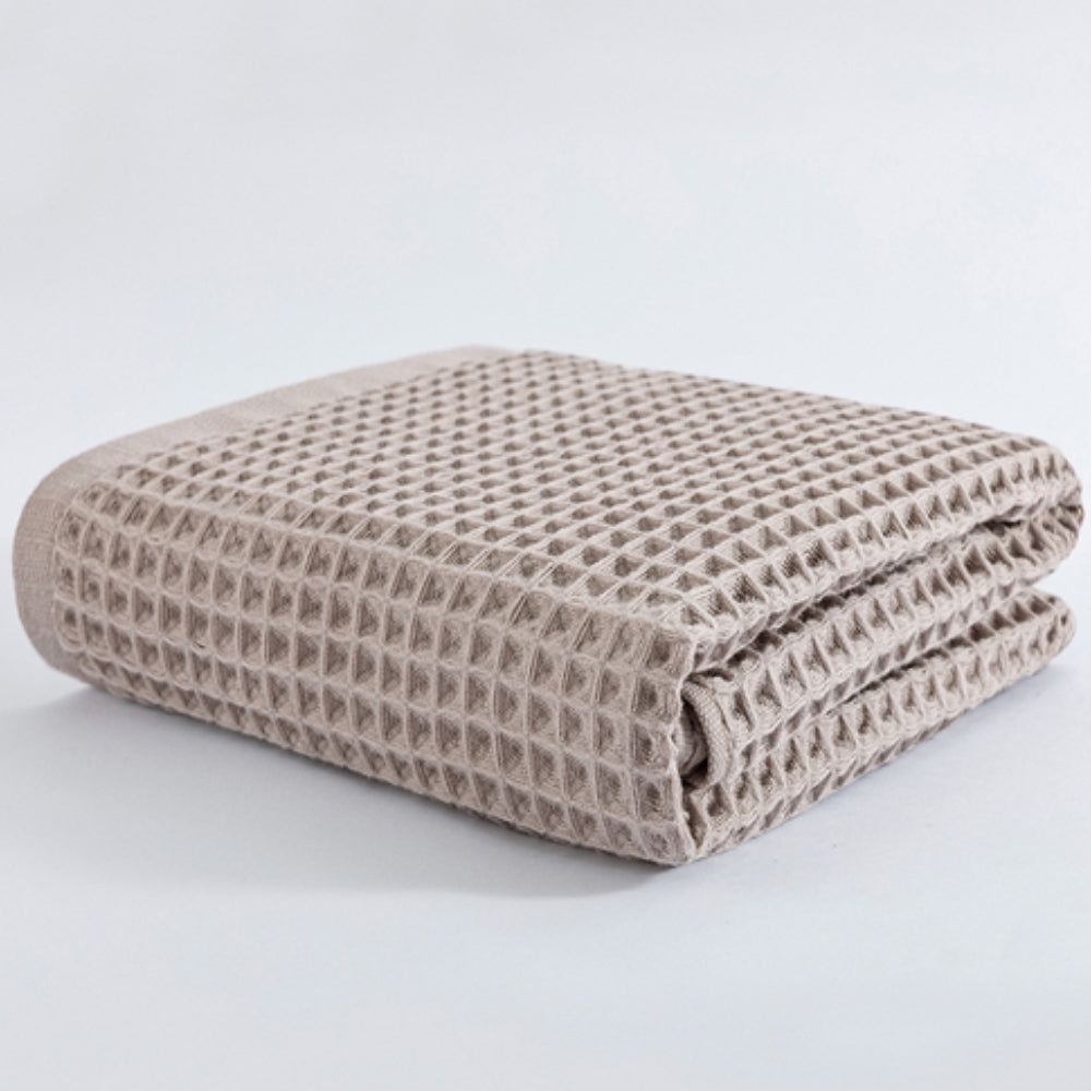 Waffle weave bath towel in pastel colors including pink, blue, white, and gray, ultra-absorbent and quick-drying