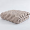 Waffle weave bath towel in pastel colors including pink, blue, white, and gray, ultra-absorbent and quick-drying