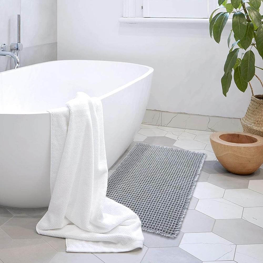 Anti-slip waffle bathroom rug in natural beige with textured weave, absorbent bath mat for shower and bathroom floor