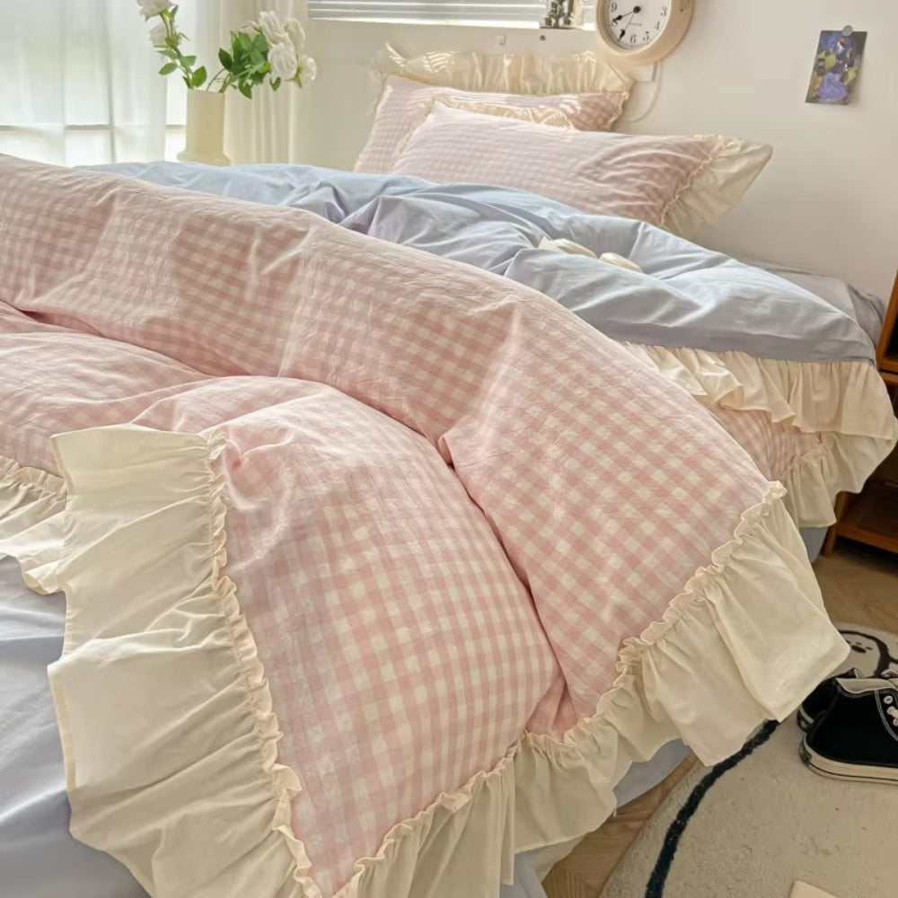 Pastel pink gingham ruffle bedding set with cream frilled edges, soft cotton duvet cover and pillowcases in romantic shabby chic bedroom decor