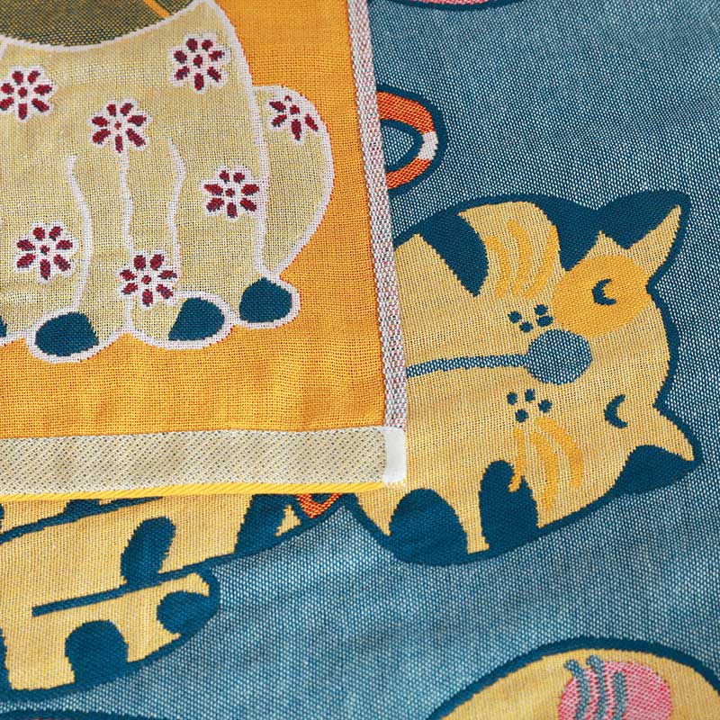 Colorful kids blanket with cartoon cat design in orange, yellow, and blue, soft cotton throw for bedroom or nursery