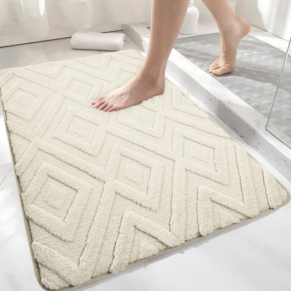 White geometric bath mat with diamond pattern, absorbent and non-slip plush rug for bathroom, shower, or tub