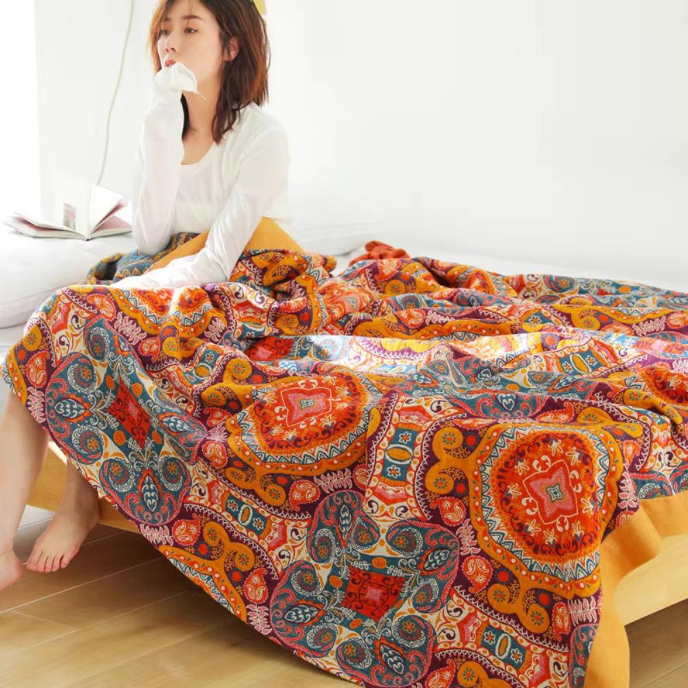 Bohemian patchwork quilt blanket with vibrant mandala and paisley patterns in orange, red, and blue – lightweight bedspread or throw