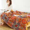 Bohemian patchwork quilt blanket with vibrant mandala and paisley patterns in orange, red, and blue – lightweight bedspread or throw