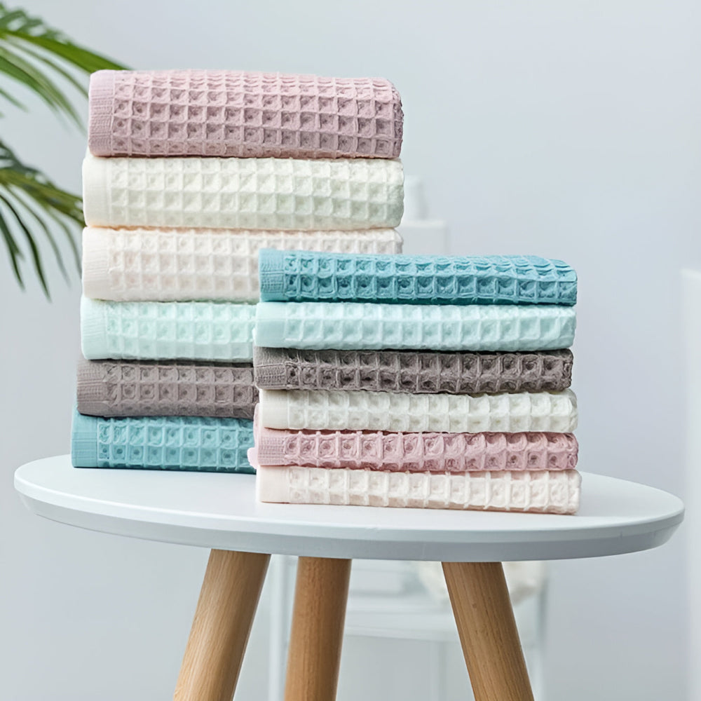 Waffle weave bath towel in pastel colors including pink, blue, white, and gray, ultra-absorbent and quick-drying