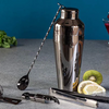 Premium stainless steel cocktail shaker set with mixing spoon, citrus slices, and bar tools – professional bartender kit for home and party drinks