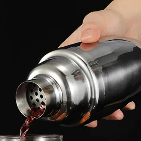 Premium stainless steel cocktail shaker set with mixing spoon, citrus slices, and bar tools – professional bartender kit for home and party drinks