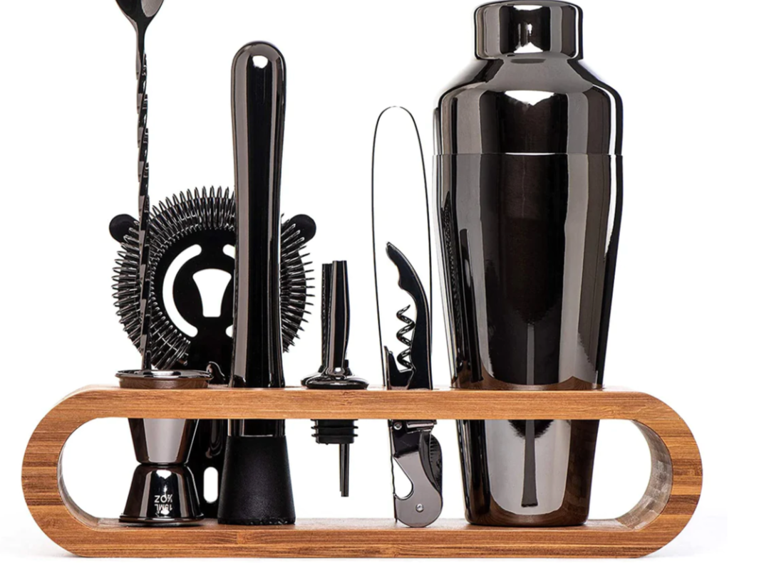 Premium stainless steel cocktail shaker set with mixing spoon, citrus slices, and bar tools – professional bartender kit for home and party drinks