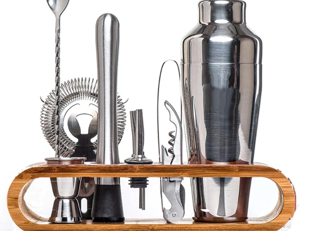 Premium stainless steel cocktail shaker set with mixing spoon, citrus slices, and bar tools – professional bartender kit for home and party drinks