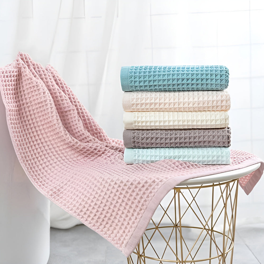 Waffle weave bath towel in pastel colors including pink, blue, white, and gray, ultra-absorbent and quick-drying
