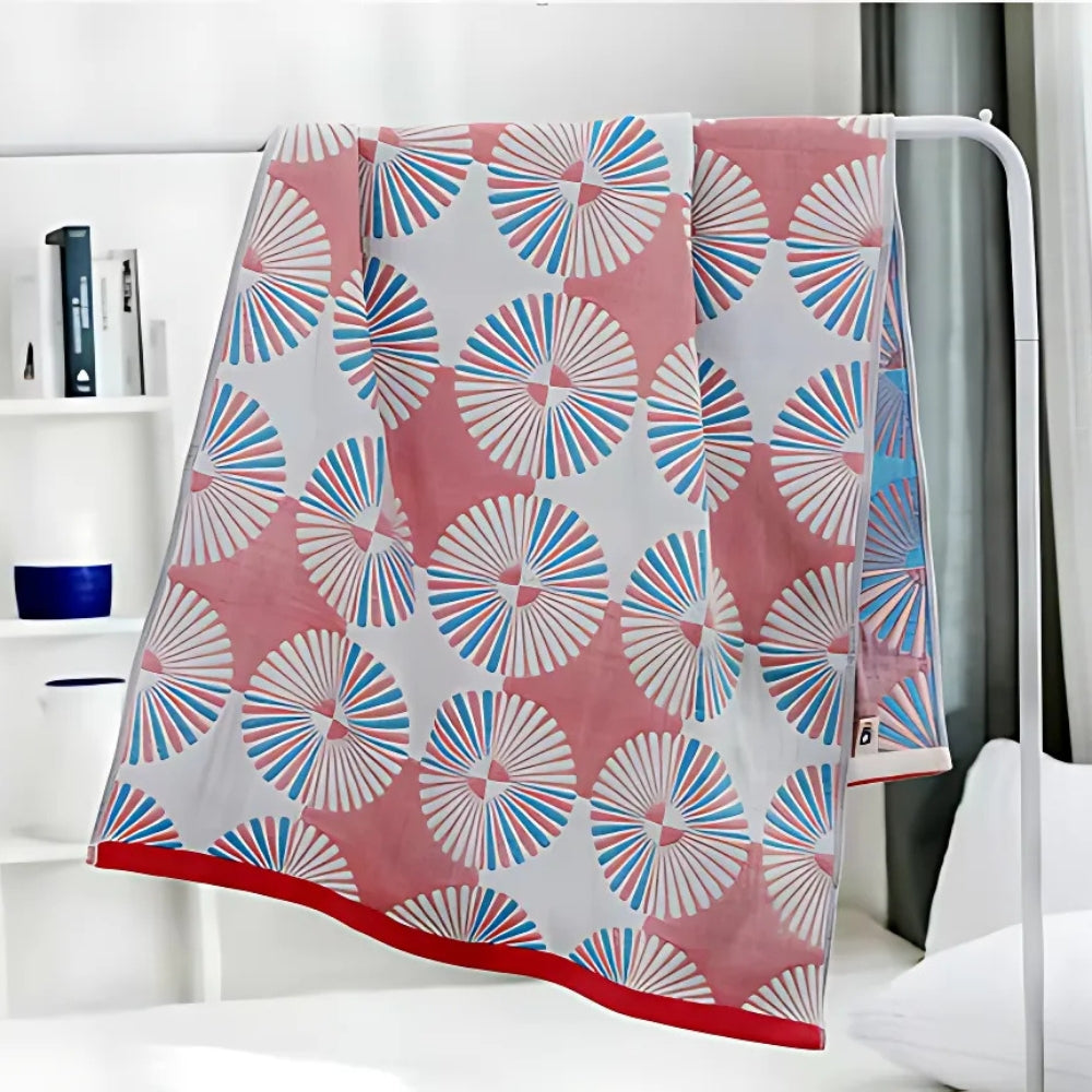 Light green and white throw blanket with modern fan circle pattern, soft decorative accent for sofa or bed