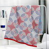 Light green and white throw blanket with modern fan circle pattern, soft decorative accent for sofa or bed
