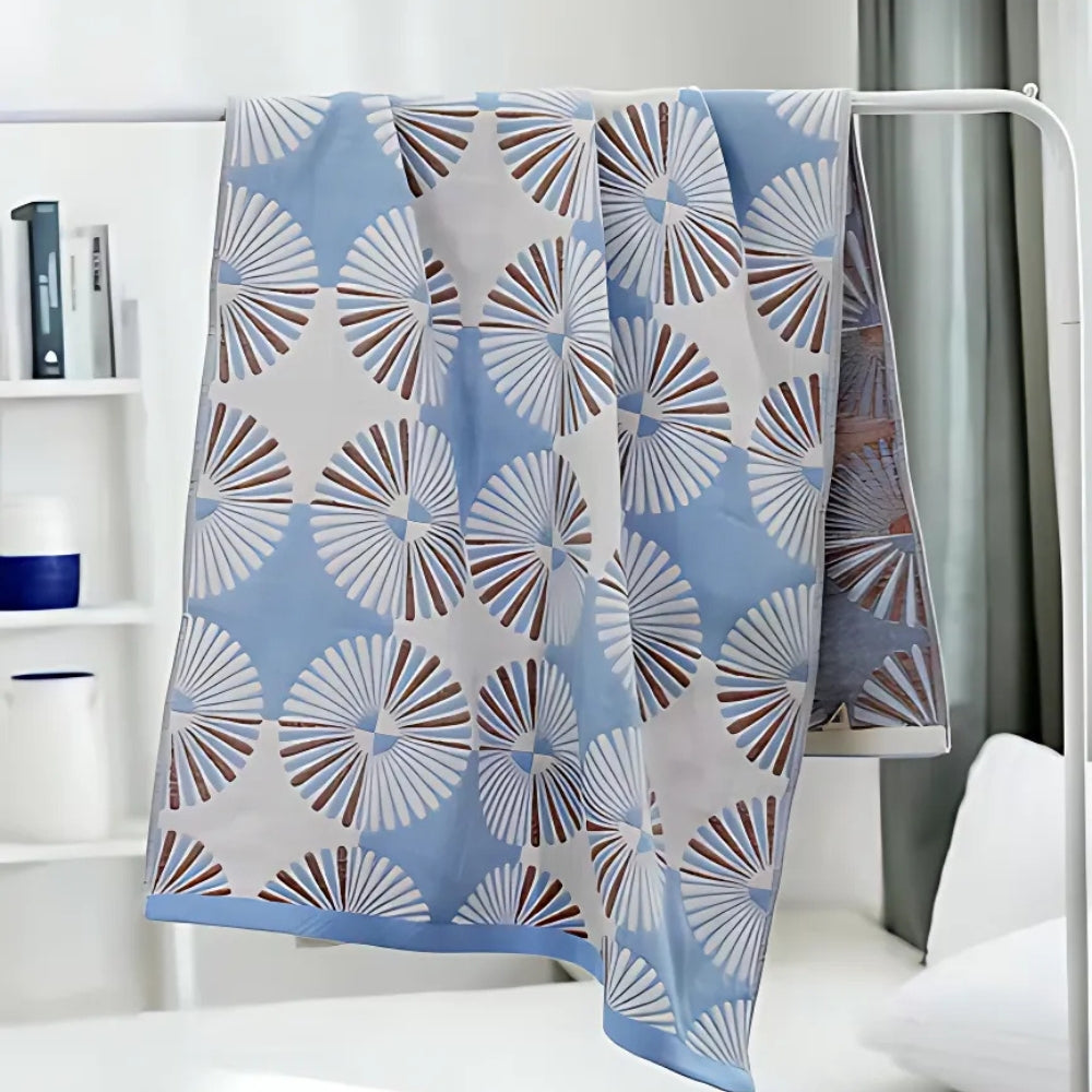 Light green and white throw blanket with modern fan circle pattern, soft decorative accent for sofa or bed