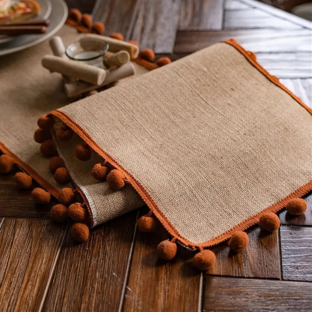 Jute table runner – Durable material – Vibrant orange pom-poms – Bohemian style for dining or living room decor