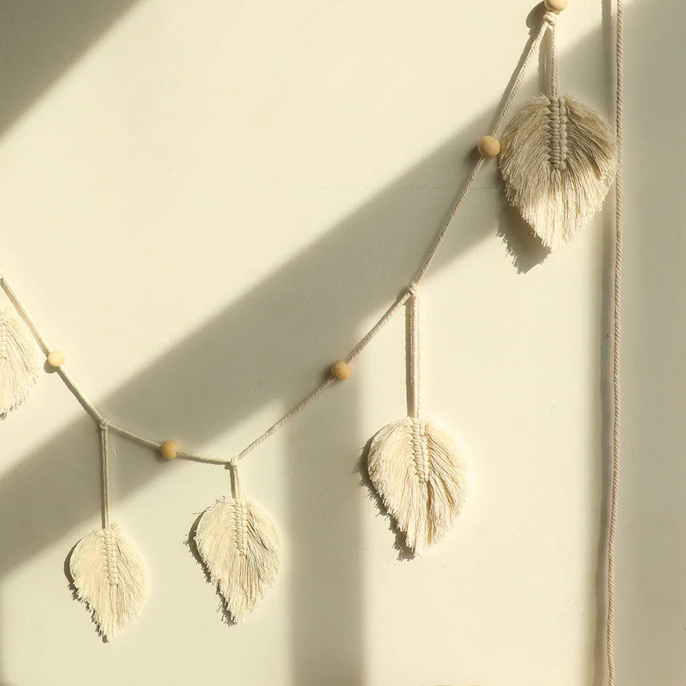 Handmade macrame leaf garland wall hanging with natural cotton rope and wooden beads for boho home decor