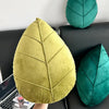 Leaf-shaped pillow – Plush material – Green design – Cozy living room accent
