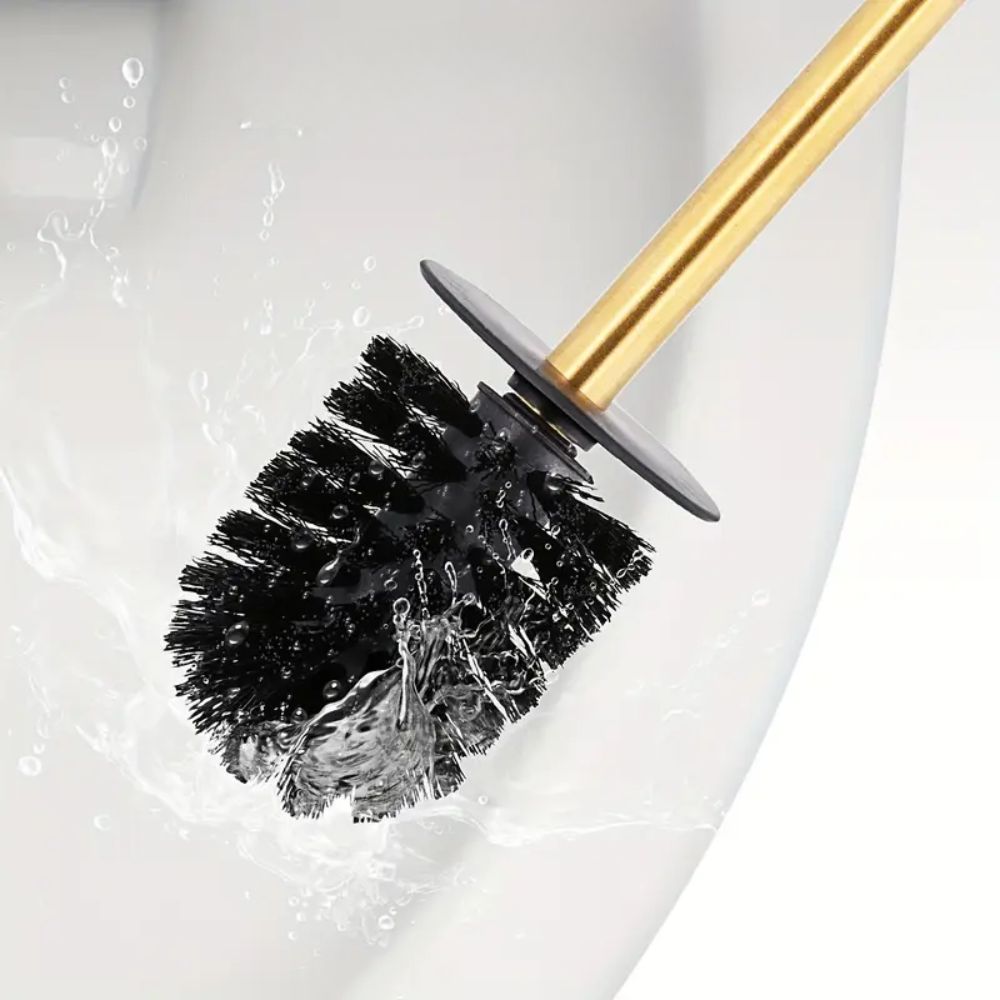 Gold toilet brush with black bristles and matching holder, modern stainless steel bathroom cleaning set