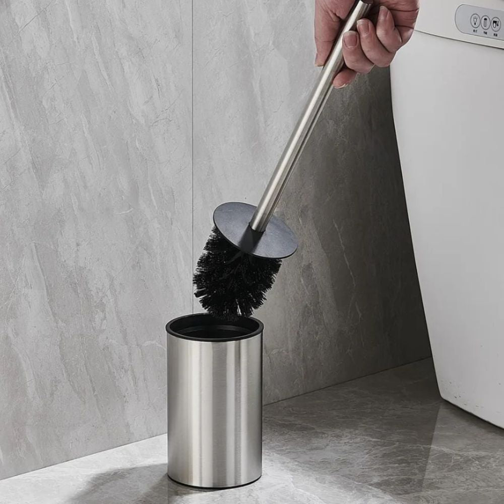 Gold toilet brush with black bristles and matching holder, modern stainless steel bathroom cleaning set