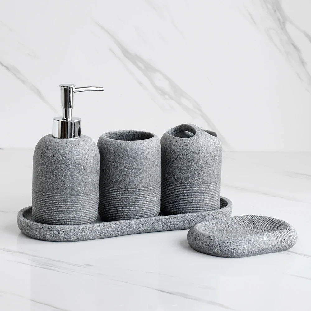 Minimalist ceramic bathroom accessory set with soap dispenser, toothbrush holder, and soap dish for modern home decor