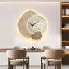 Modern LED wall clock with abstract stone design and golden deer, decorative timepiece for living room or office decor