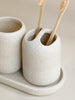 Minimalist ceramic bathroom accessory set with soap dispenser, toothbrush holder, and soap dish for modern home decor