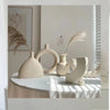 Set of modern abstract ceramic vases in matte beige, minimalist home decor for living room or dining table display