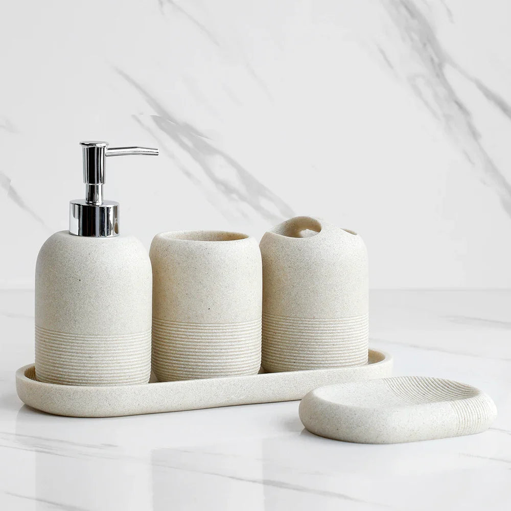 Minimalist ceramic bathroom accessory set with soap dispenser, toothbrush holder, and soap dish for modern home decor
