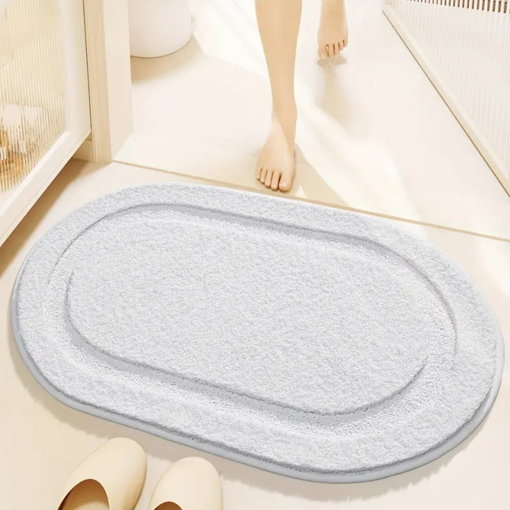 Beige oval bathroom rug, soft absorbent bath mat with non-slip backing, plush microfiber floor rug for tub or shower