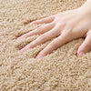 Beige oval bathroom rug, soft absorbent bath mat with non-slip backing, plush microfiber floor rug for tub or shower