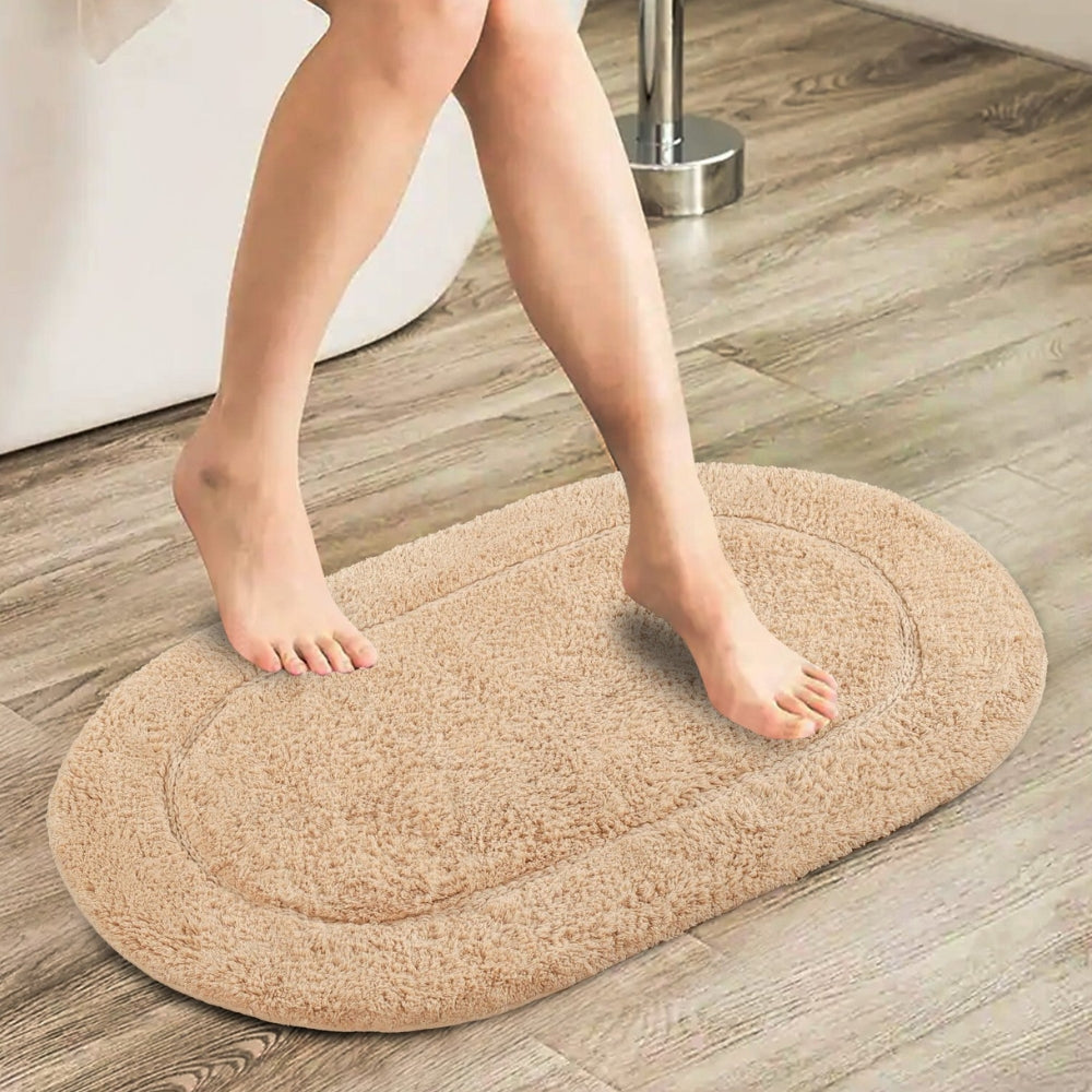 Beige oval bathroom rug, soft absorbent bath mat with non-slip backing, plush microfiber floor rug for tub or shower