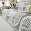 Modern geometric grey and white sofa cover with abstract wave pattern and fringe edges – washable couch slipcover for living room furniture protection