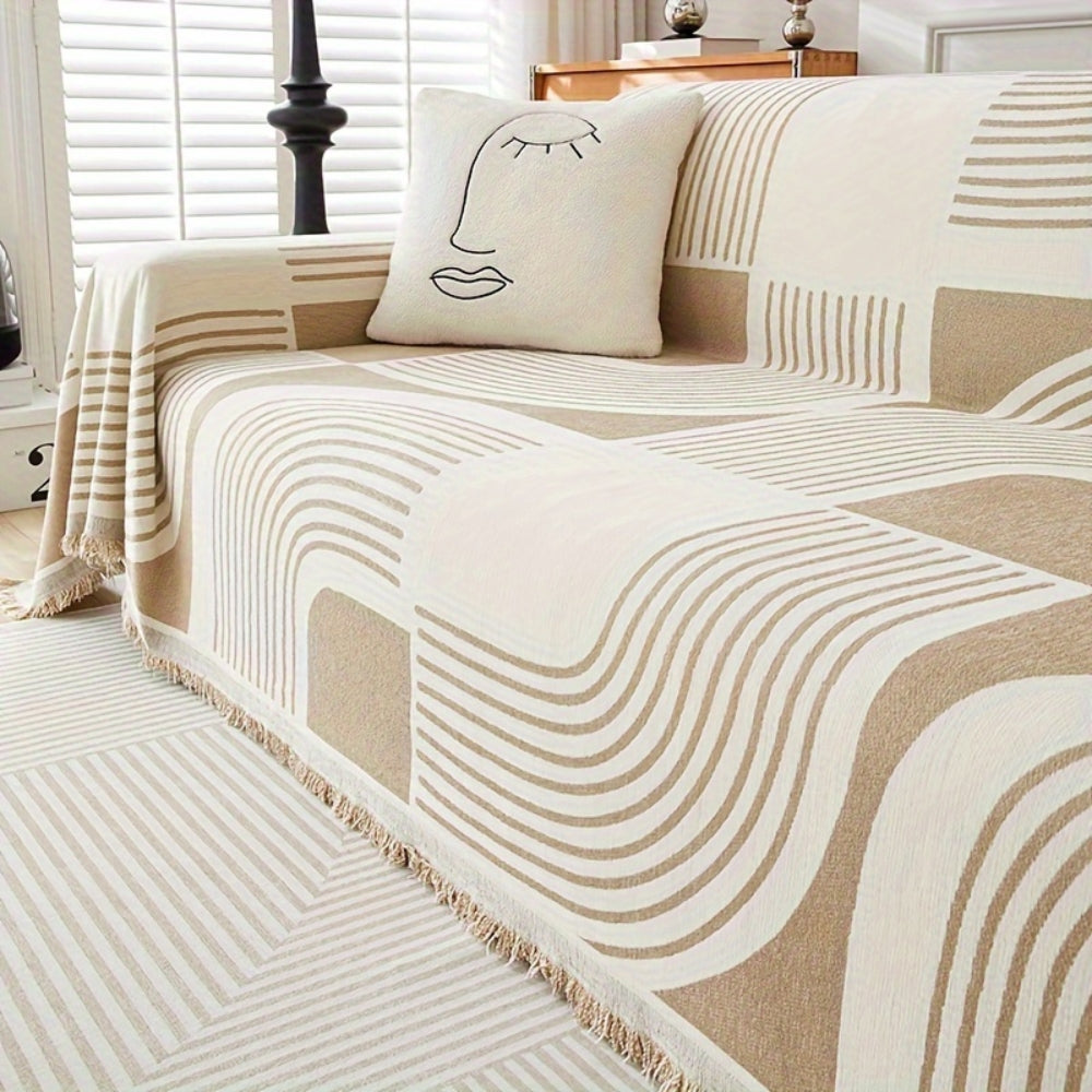 Modern geometric grey and white sofa cover with abstract wave pattern and fringe edges – washable couch slipcover for living room furniture protection