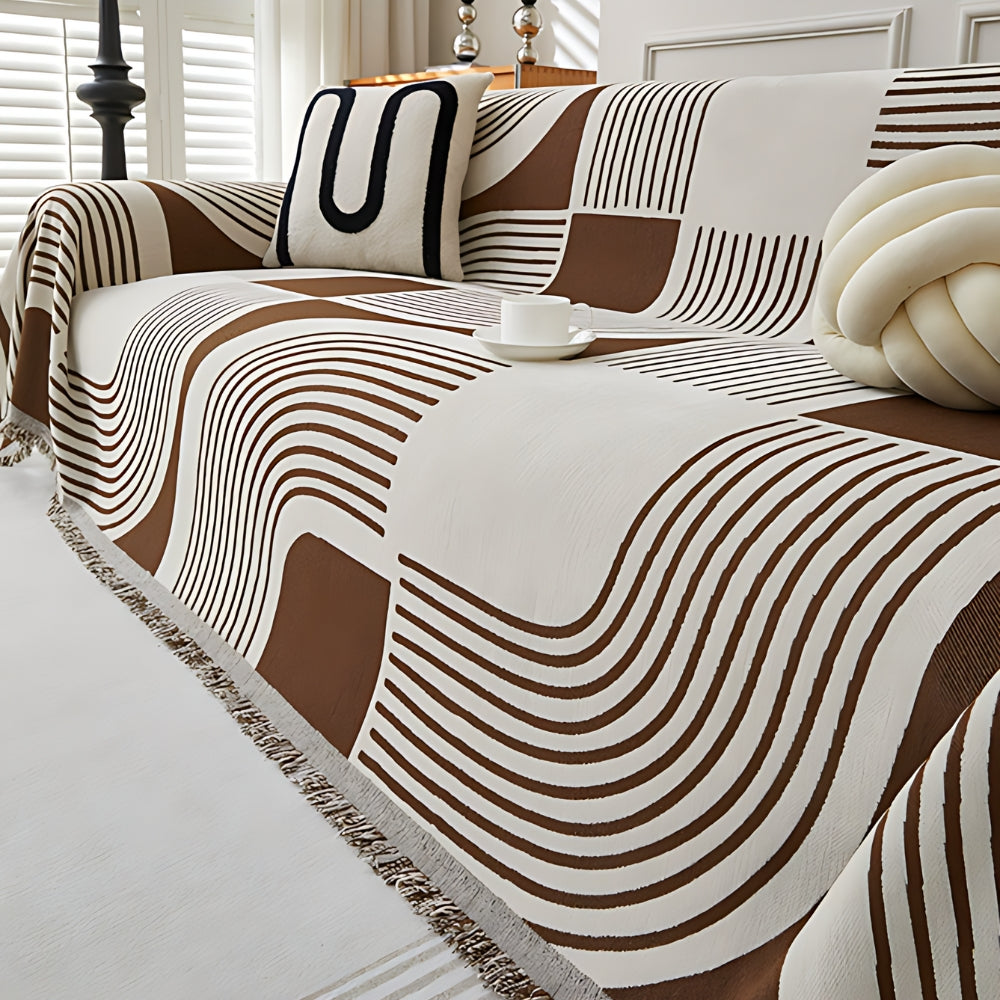 Modern geometric grey and white sofa cover with abstract wave pattern and fringe edges – washable couch slipcover for living room furniture protection