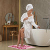 Pink bath mat with bold red ‘Get Naked’ lettering, soft absorbent funny bathroom rug for modern decor