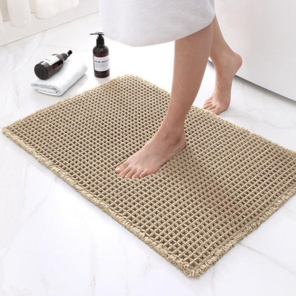 Anti-slip waffle bathroom rug in natural beige with textured weave, absorbent bath mat for shower and bathroom floor