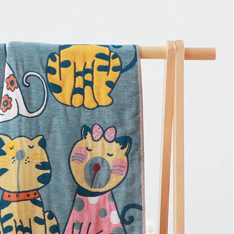 Colorful kids blanket with cartoon cat design in orange, yellow, and blue, soft cotton throw for bedroom or nursery