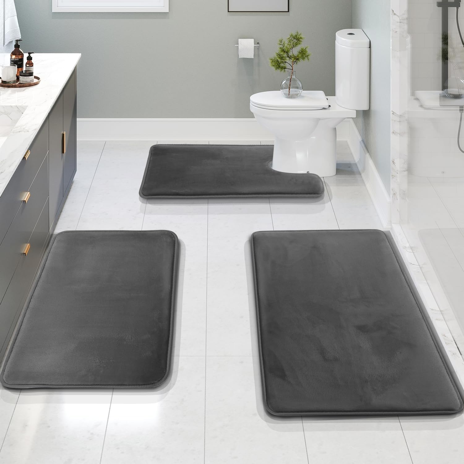 Set of three dark gray memory foam bathroom rugs with non-slip backing, soft absorbent bath mats for toilet, shower, and vanity area