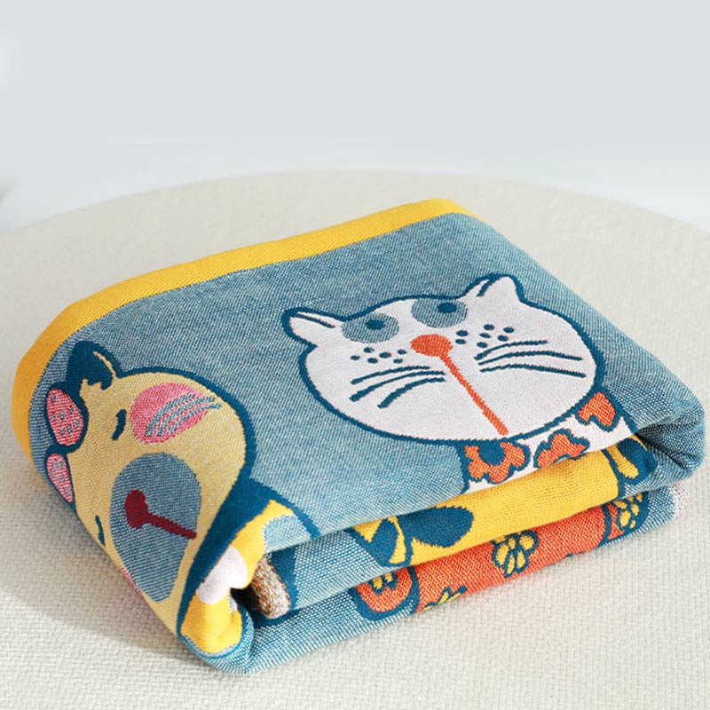 Colorful kids blanket with cartoon cat design in orange, yellow, and blue, soft cotton throw for bedroom or nursery