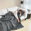 Plush grey faux fur throw blanket with ribbed texture, soft and warm decorative couch or bed cover