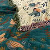 Bohemian sofa throw blanket with teal background, bird and floral patterns, and fringe edges, decorative couch cover for living room