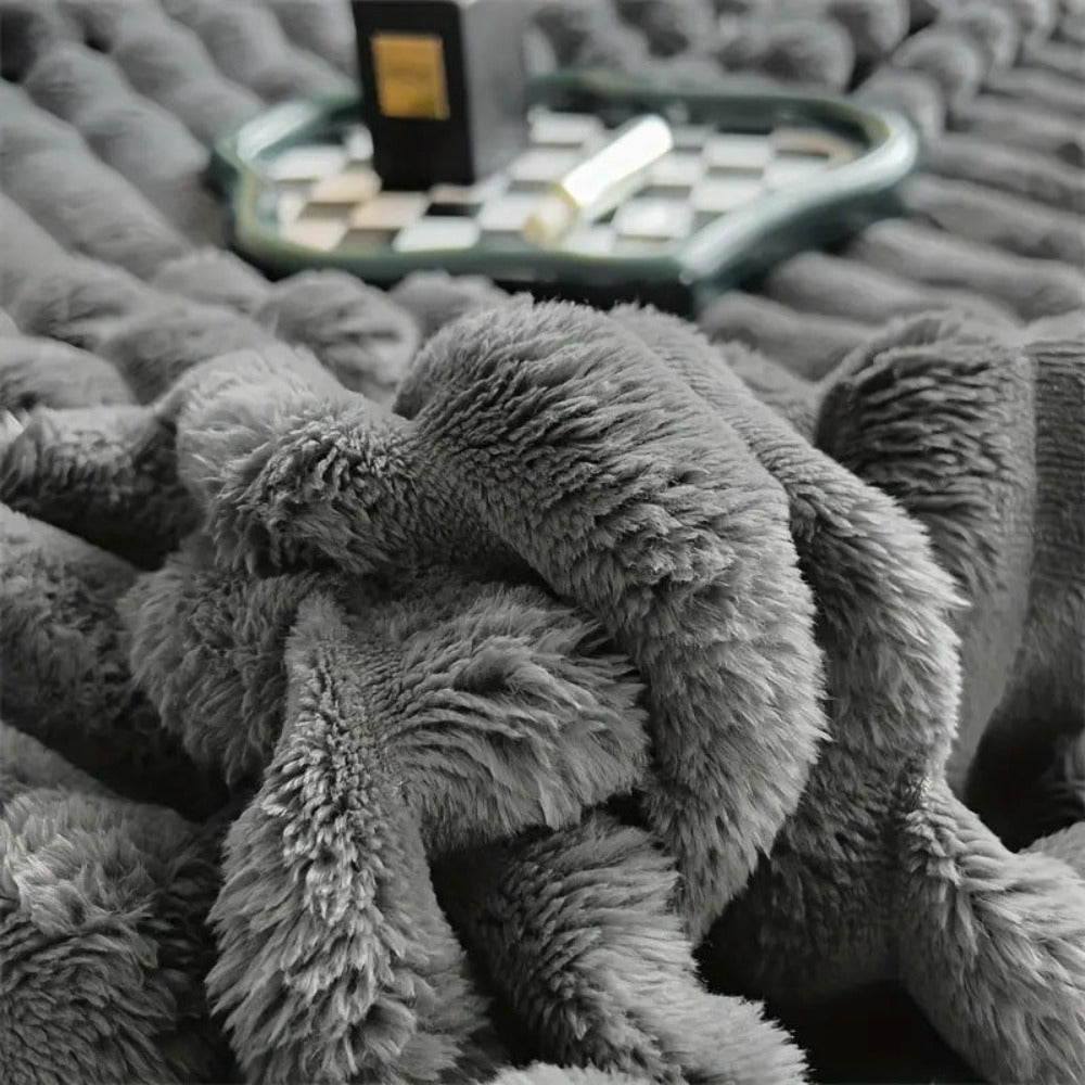 Plush grey faux fur throw blanket with ribbed texture, soft and warm decorative couch or bed cover