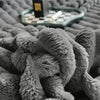 Plush grey faux fur throw blanket with ribbed texture, soft and warm decorative couch or bed cover