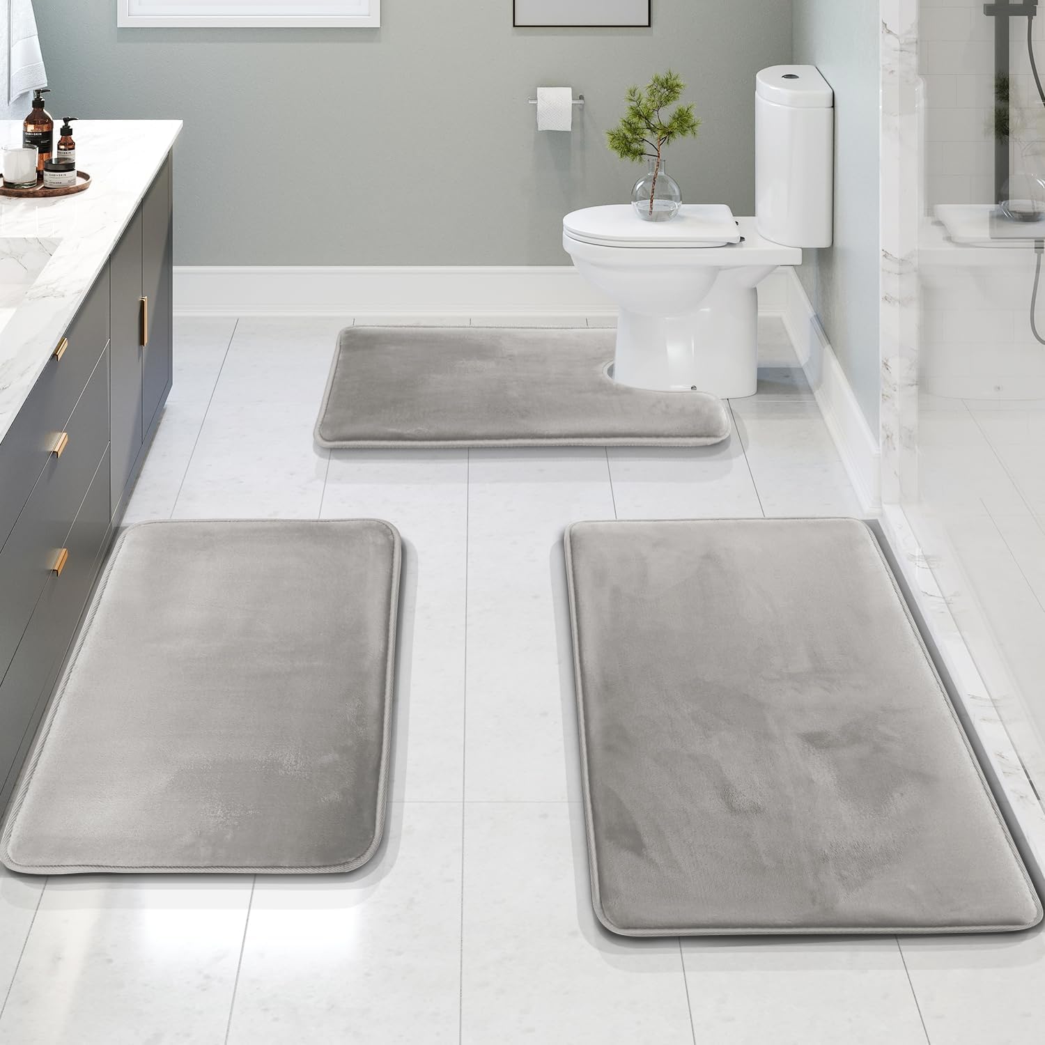 Set of three dark gray memory foam bathroom rugs with non-slip backing, soft absorbent bath mats for toilet, shower, and vanity area