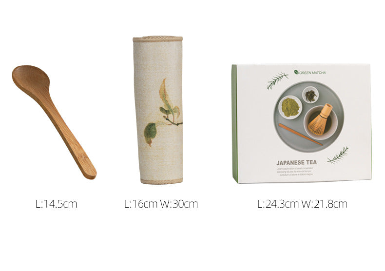 Japanese matcha set with white ceramic tea bowl and pink cherry blossom design, bamboo whisk, sifter, and tea scoop for traditional tea ceremony