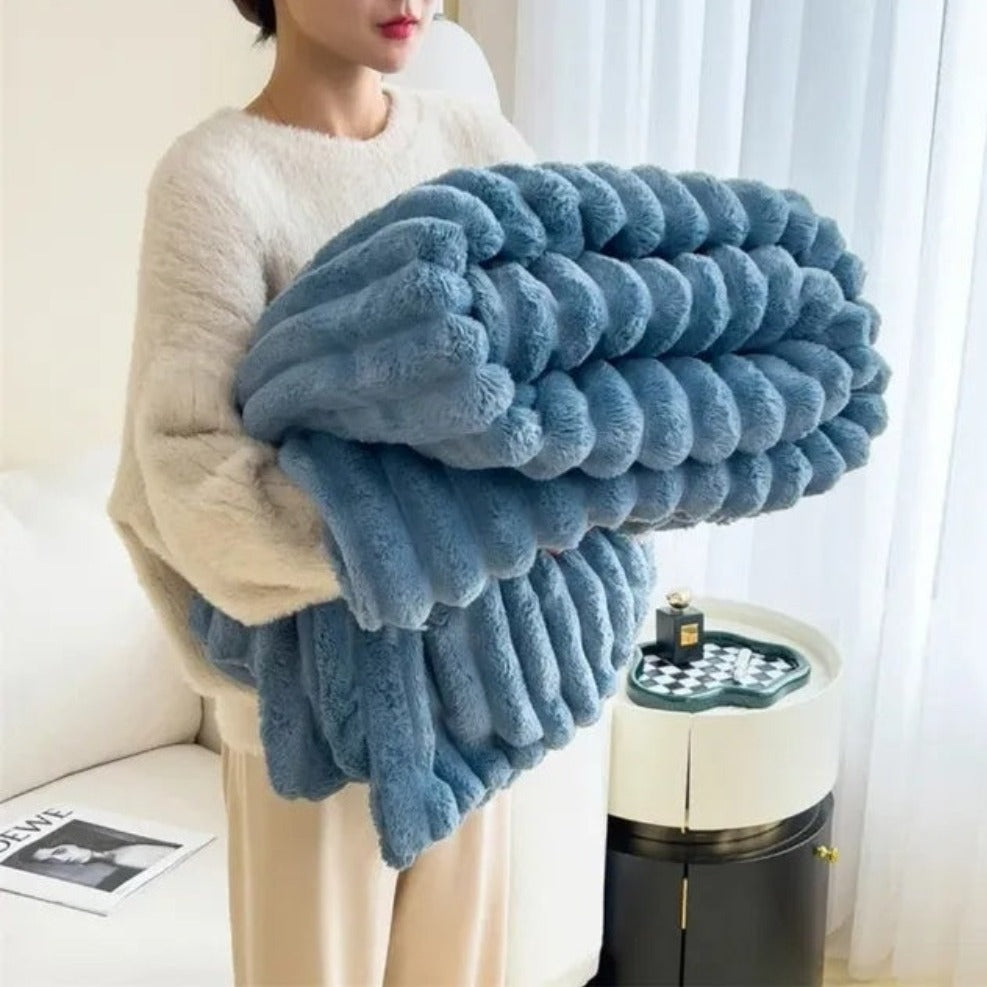Plush grey faux fur throw blanket with ribbed texture, soft and warm decorative couch or bed cover