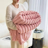 Plush grey faux fur throw blanket with ribbed texture, soft and warm decorative couch or bed cover